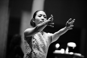 Megan Kurashige in black and white reaching front