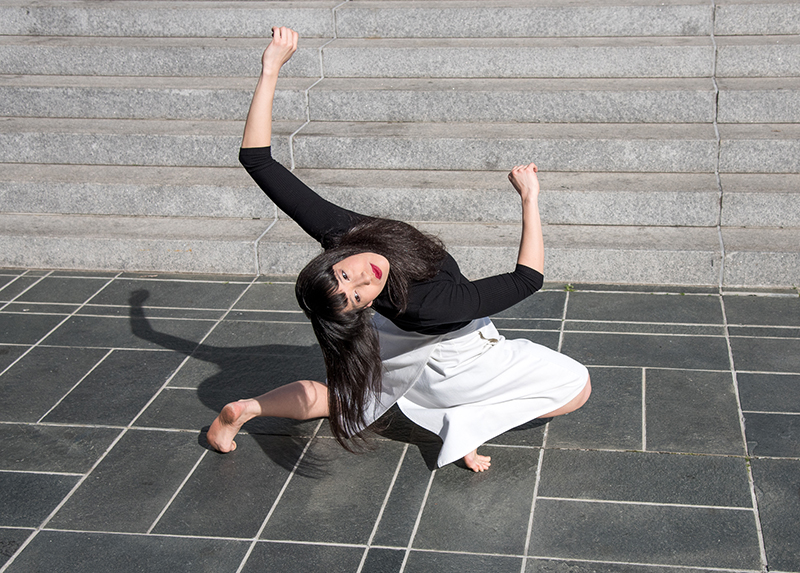 Katie Wong dancing near steps