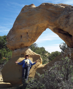 Cathy Intemann standing under a rock arch