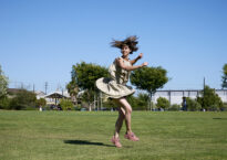 Brittany Delany whirling in park
