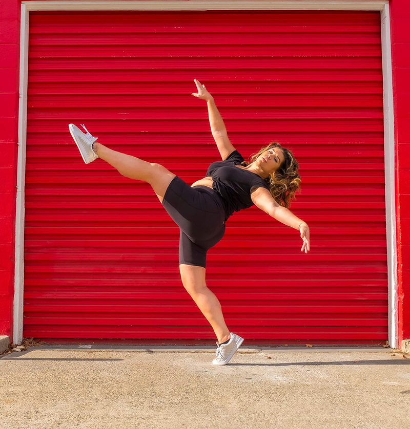 Amy doing a front extension in front of a red garage.