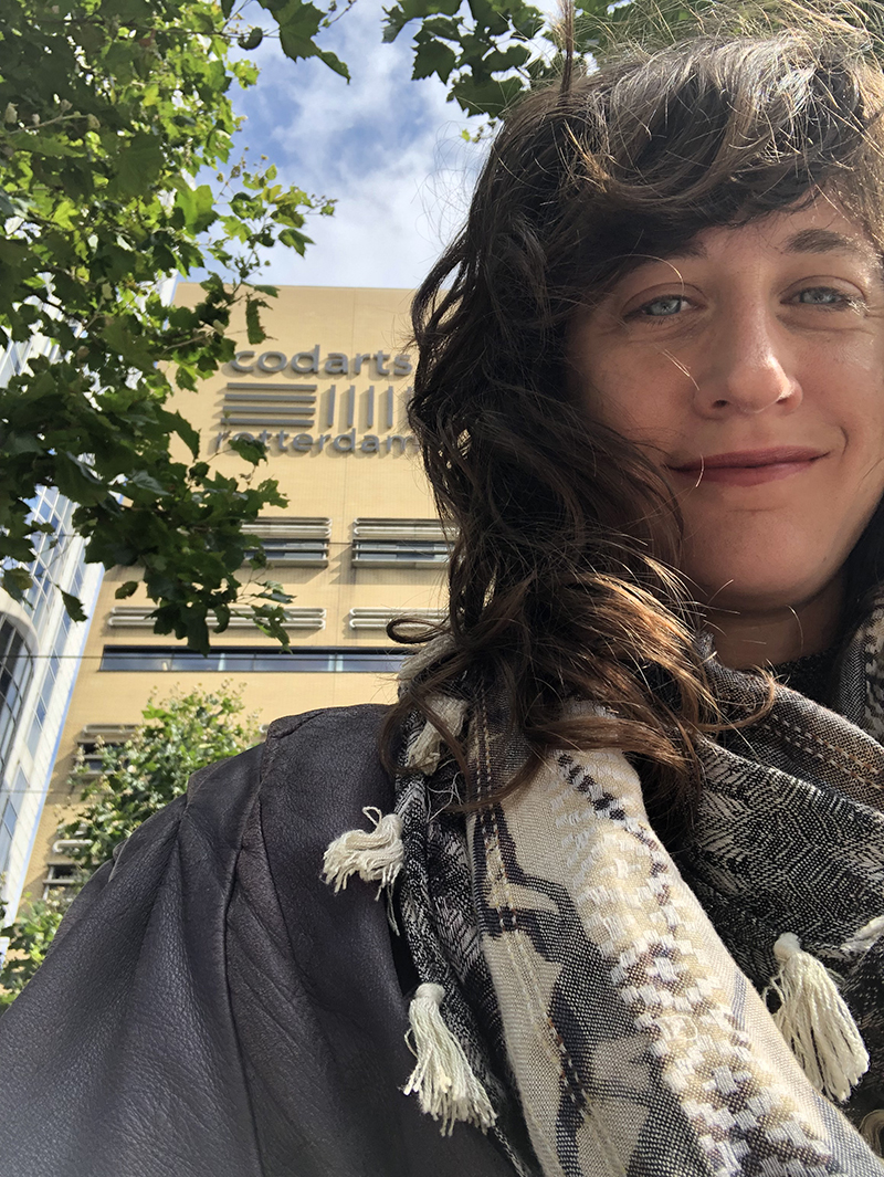 Selfie of Giulia wearing a scarf in front of Codarts building
