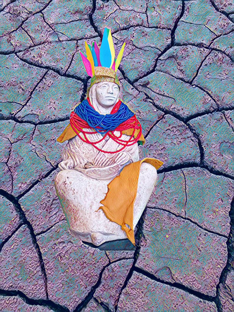 A sculpture with Indigenous tropes like a feathered headband and beads. The backdrop is cracked earth.