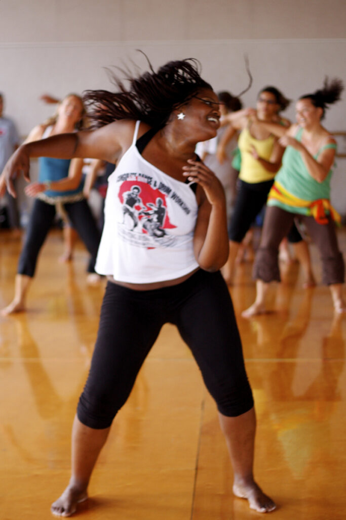 Muisi-kongo leads a class in a dance studio. Her hair whips around her.