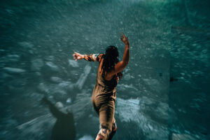 Cherie Hill dancing with turquoise backdrop