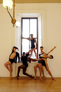 five mxn dancers en pointe in a window