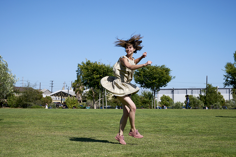 Brittany Delany whirling in park