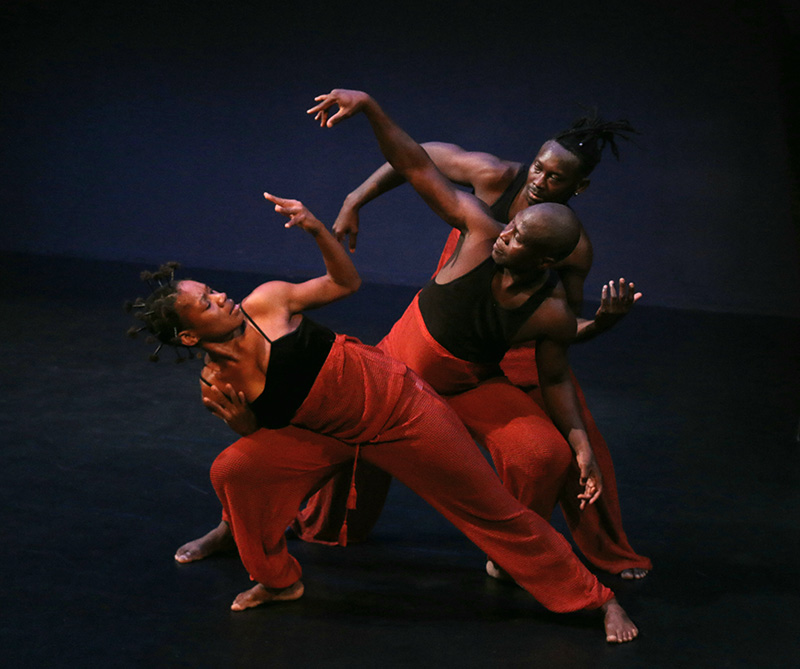 Three dancers lunge in front of one another in the 2019 Africa Remix performance.
