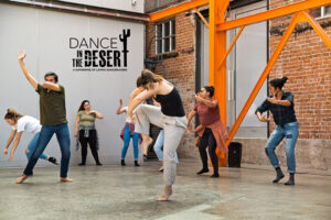 Several dancers moving in a studio