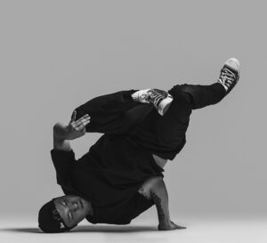 Krops balancing on his head and one hand upside down.