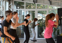 Dancers in a studio mid-clap