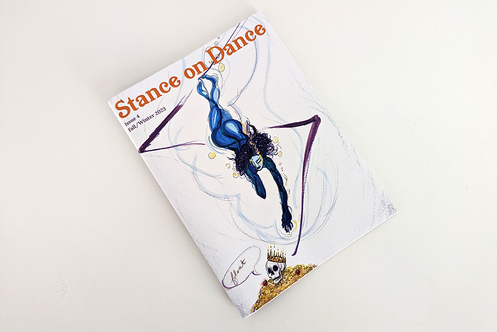 A copy of Stance on Dance print publication sitting on a white desk.