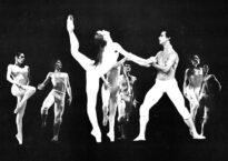 An old photo of a paw de deux with the woman in an extreme arabesque and the man holding her hands in fourth position.