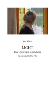 A book cover featuring a photograph of a person viewed from behind looking out a window toward a tranquil body of water, above the title LIGHT: Five Days with Janet Adler, The Story Behind the Film by Jens Wazel.